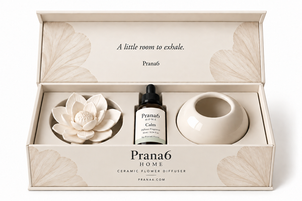 Prana6 Home Ceramic Flower Diffuser in Calm: white ceramic flower, cream ceramic base and 10 mL bottle with a gray-green label